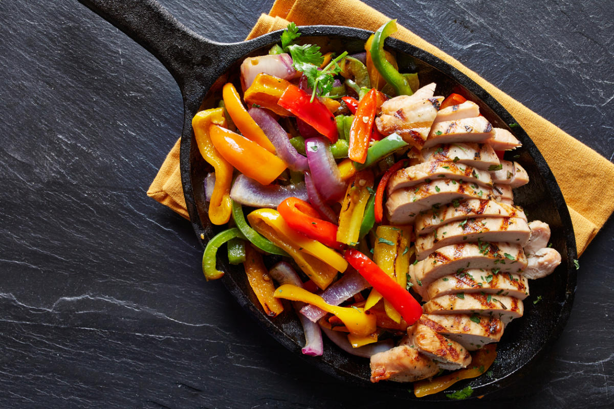 delicious fajitas skillet placed on napkin on granite counter