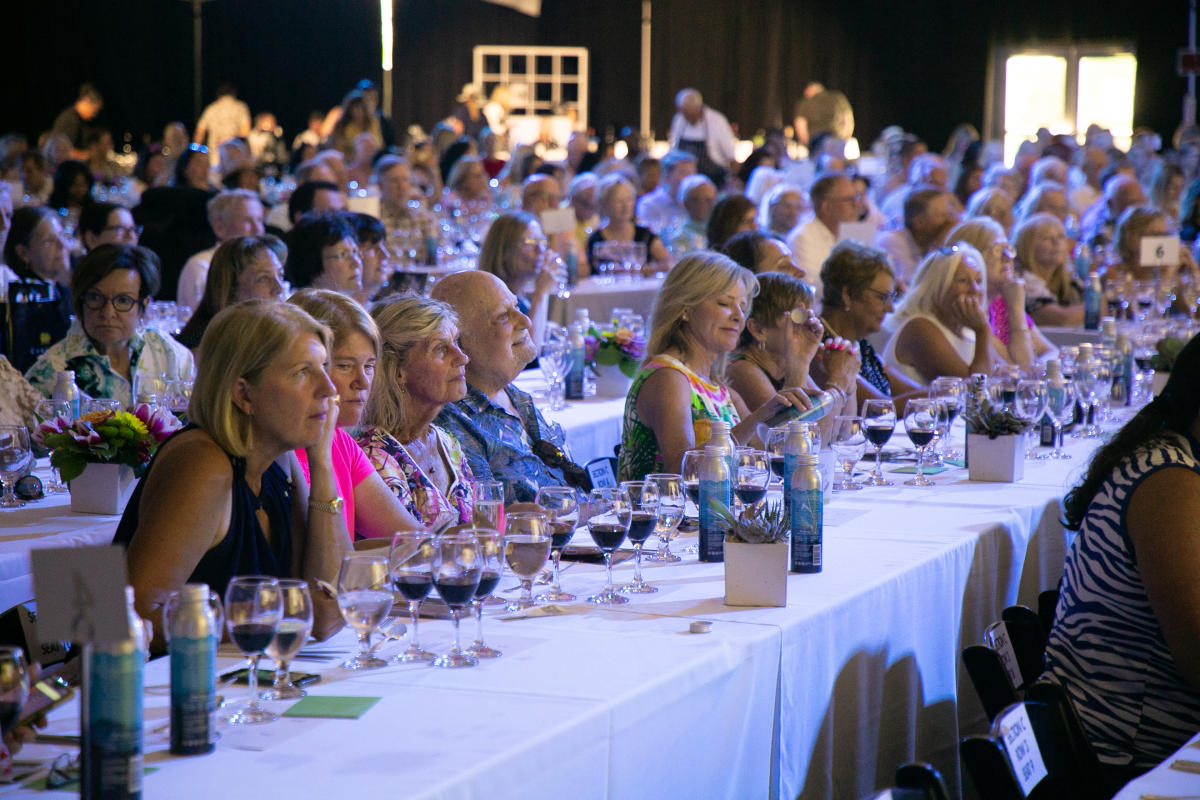 Guests at the 2022 Palm Desert Food & Wine James Beard Four-course Luncheon sit at tables.