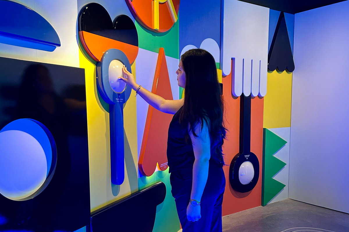 Visitor interacting with a colorful exhibit at BEC Museum in Panama City