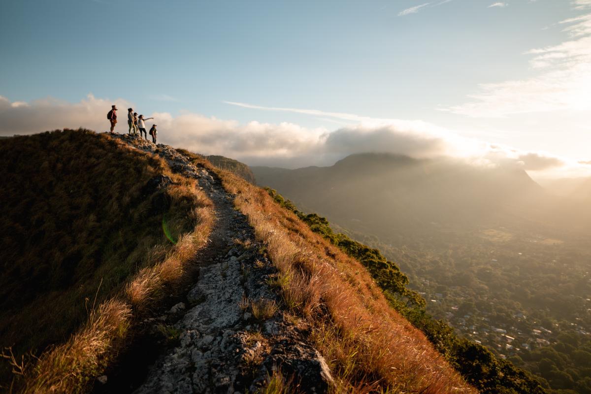 On a mountaintop at La India Dormida, a man and a woman are surrounded by friends