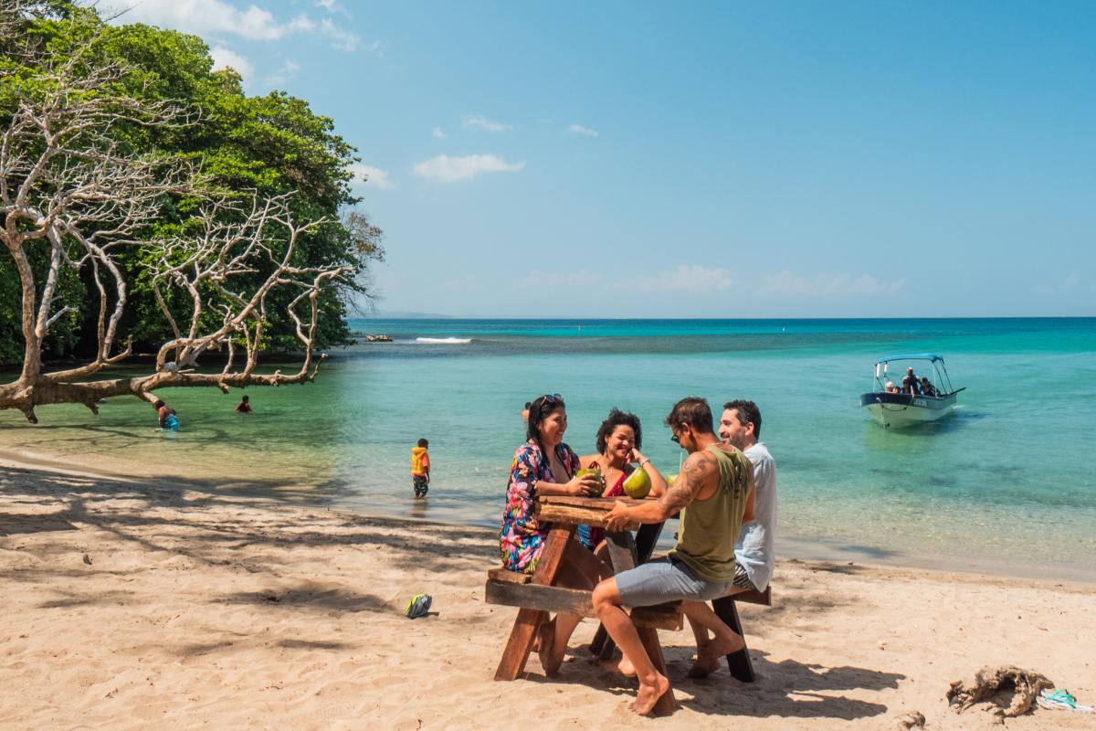 A team of friends, relishing their time together, hanging out near the water.
