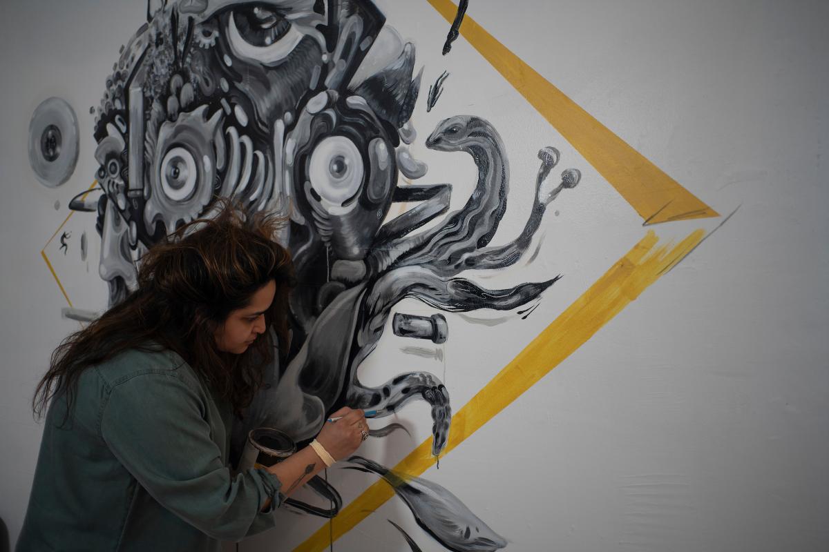 Phoenix artist Ashley Macias works on a mural.