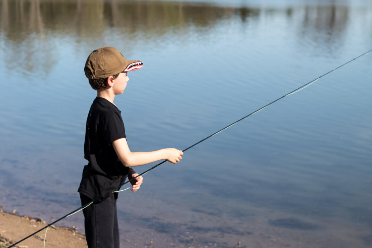 A young boy practices with a fly rod at Lake Pacawa Park.
