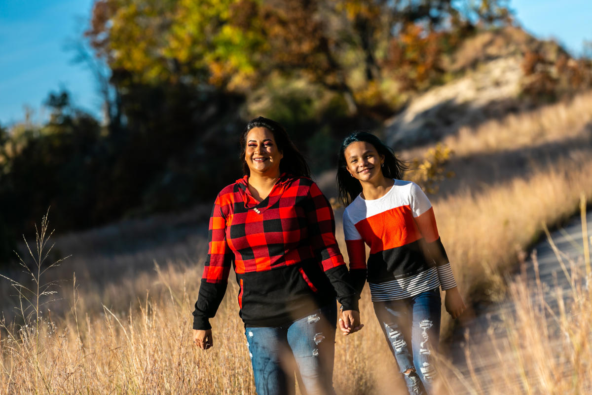 A mother and child hike in the fall.
