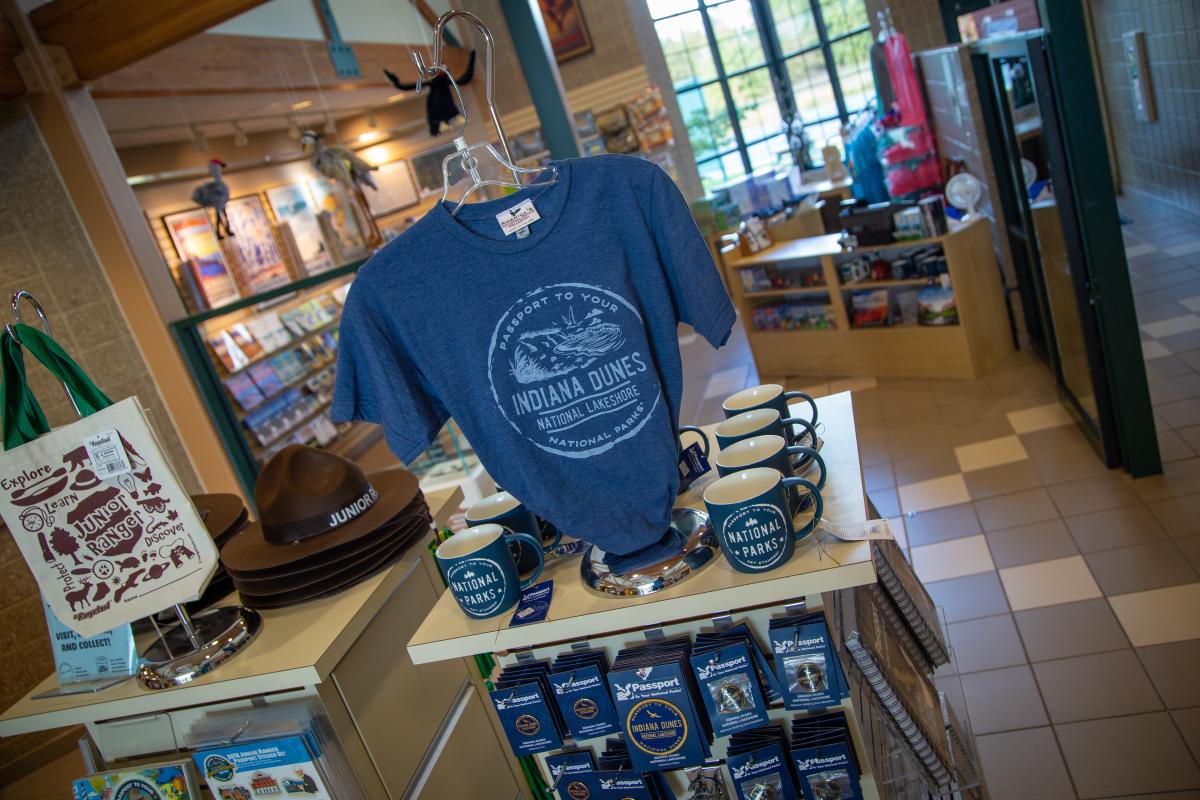 Interior of a gift shop with t-shirts, mugs, bags, and more