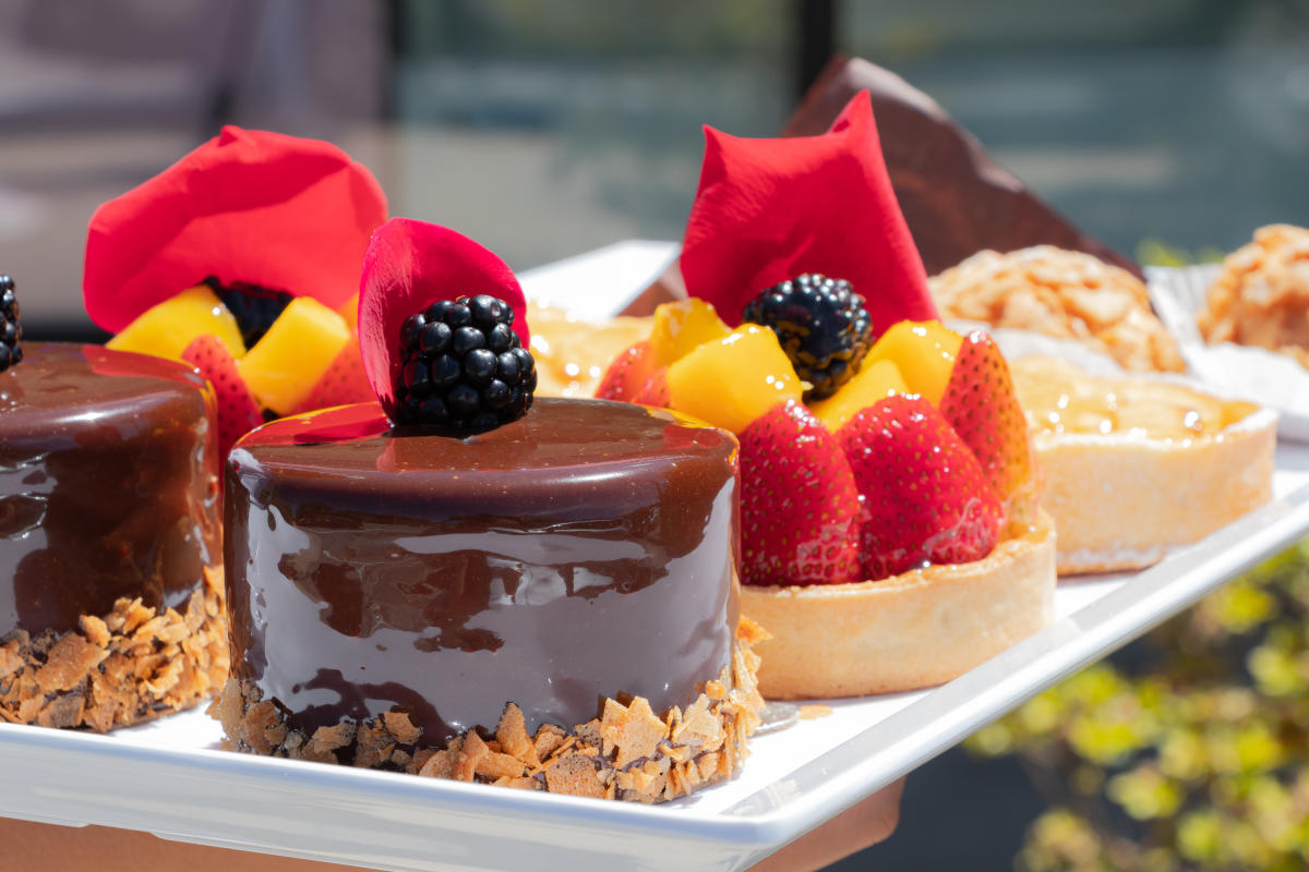 A closeup of a variety of French pastries on a rectangle white platter