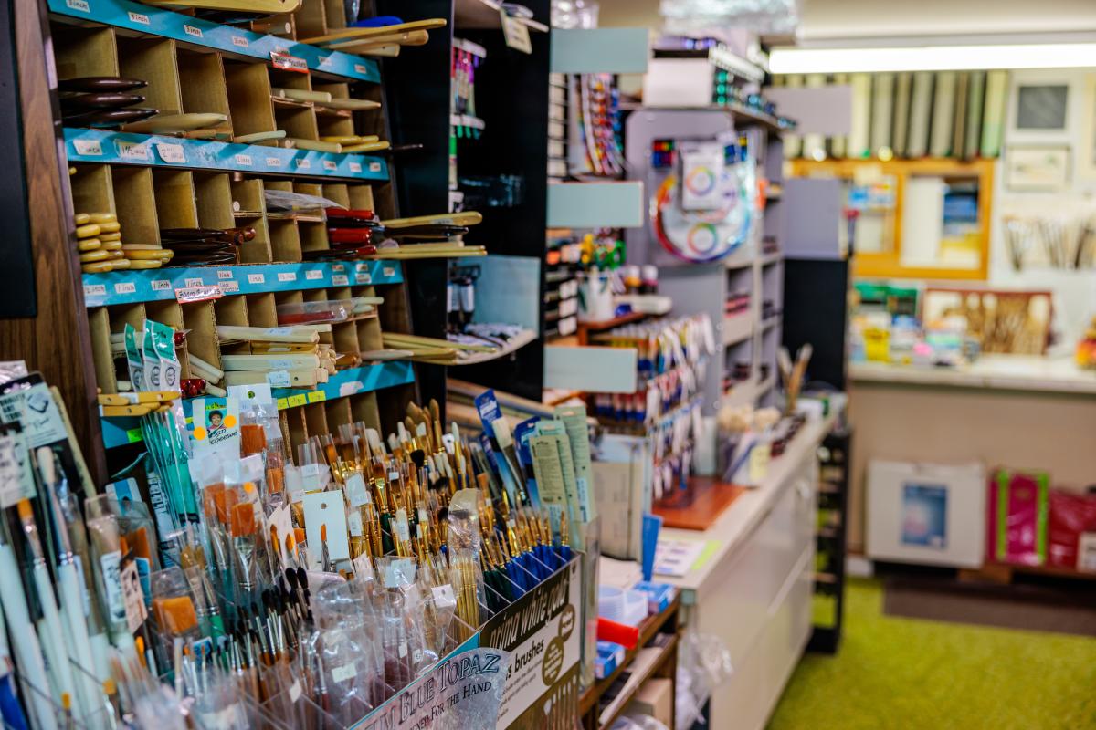 An aisle in an art store filled with various art supplies.