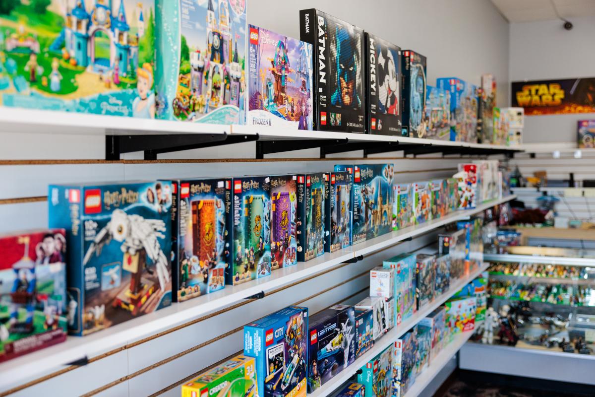 A retail wall filled with shelves of LEGO sets