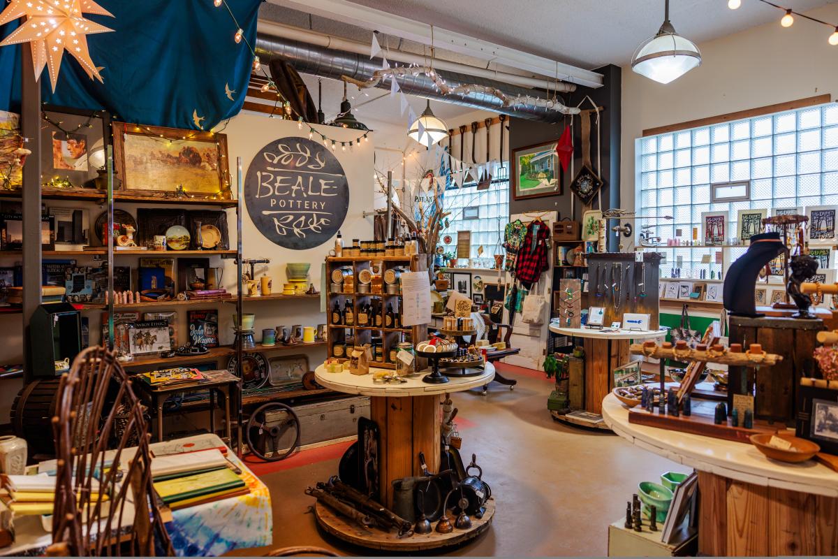 A wide shot of a store filled with gifts like pottery, jewelry, and art.