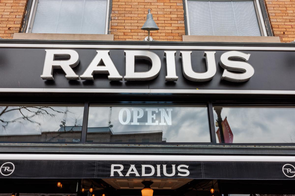 A black sign reads Radius. Underneath is an Open sign.