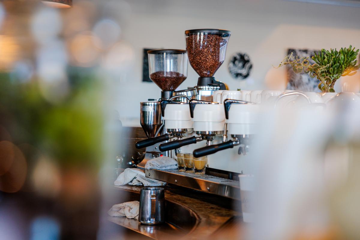 An espresso machine filled with coffee beans ready to grind