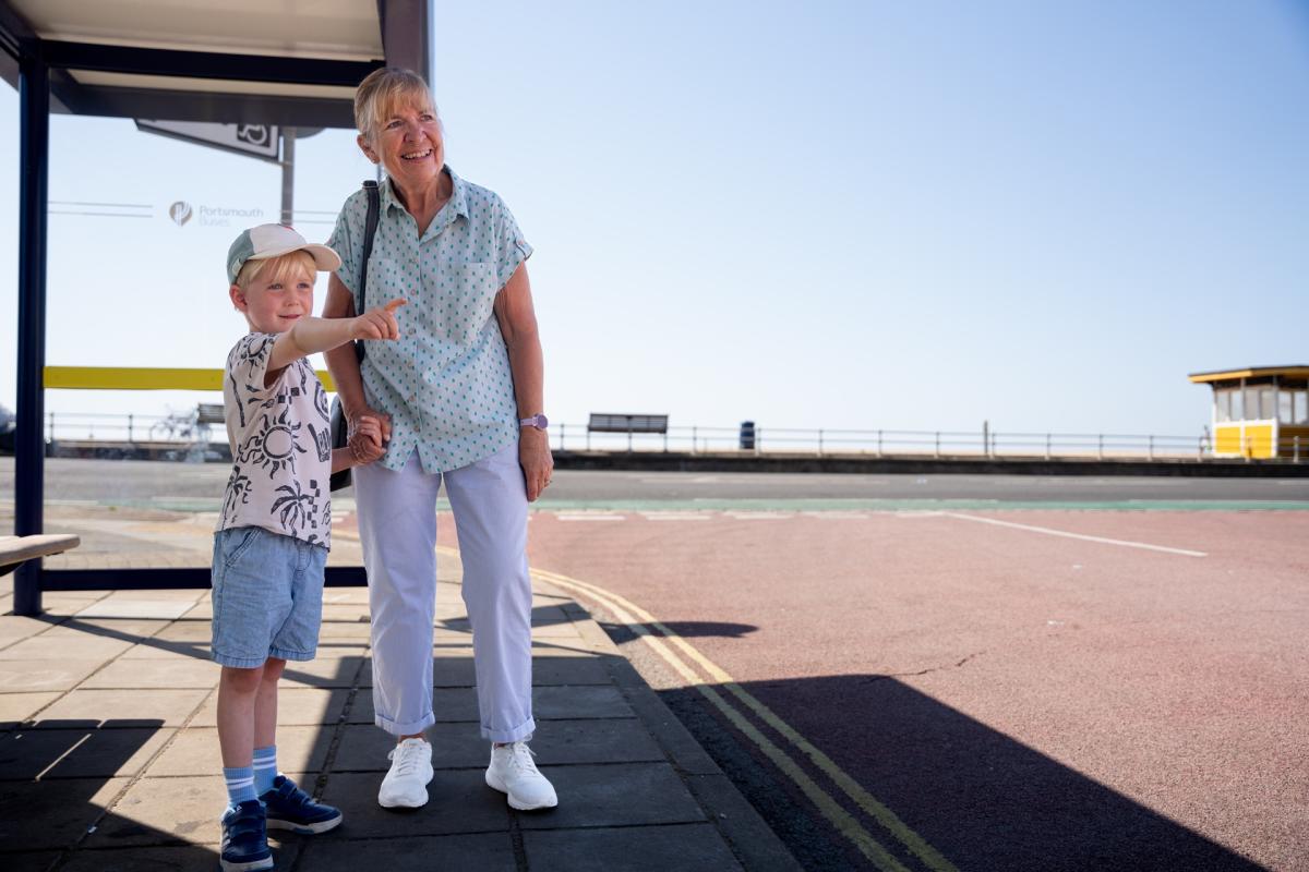 Photograph showing a child and grandparent waiting for a bus in Southsea