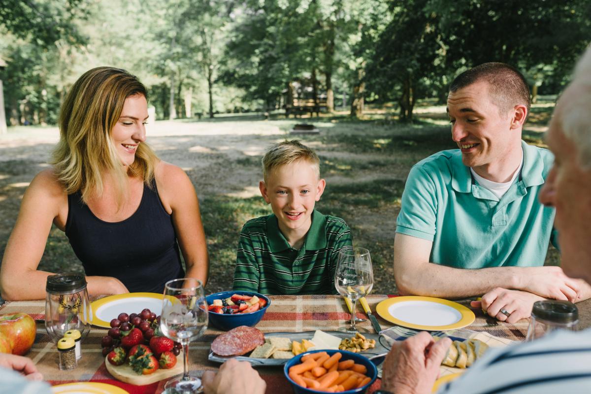 A family sitting together at a picnic table