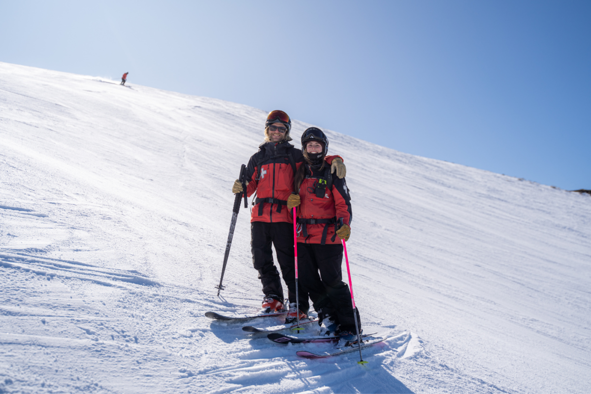 Ski patrollers Charlotte and Sam on the slopes at Coronet Peak