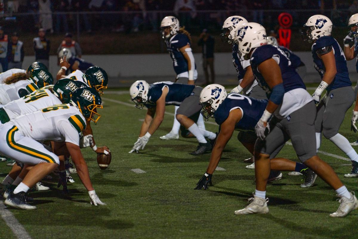 Black Hills State University and South Dakota Mines football players line up at the line of scrimmage during the Black Hills Brawl in Rapid City.
