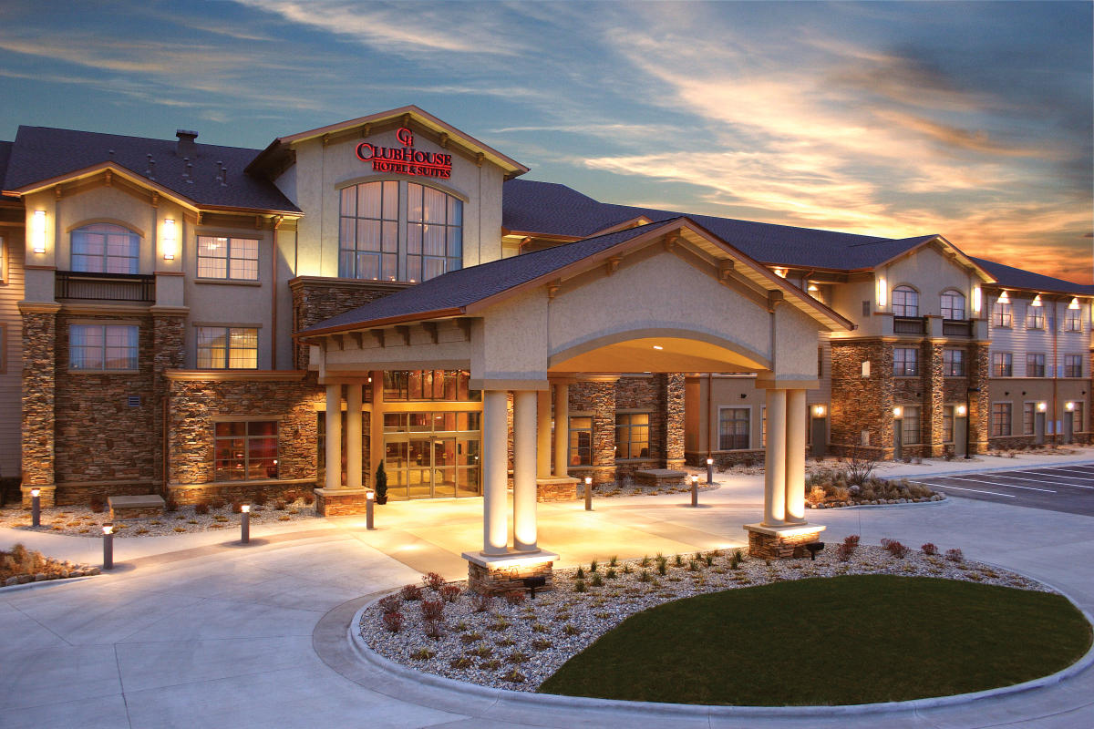 Exterior photo of The Clubhouse with sun setting in the background