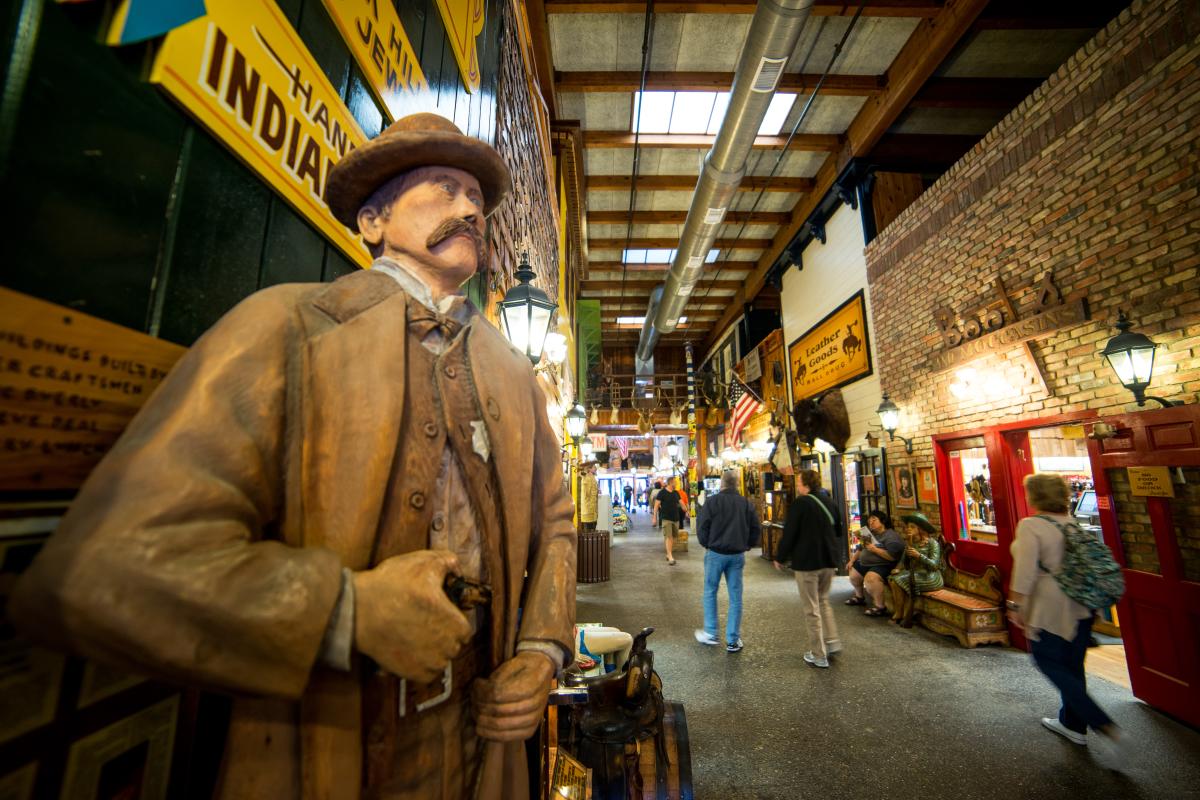 inside the wall drug store with wooden carving of western character in focus