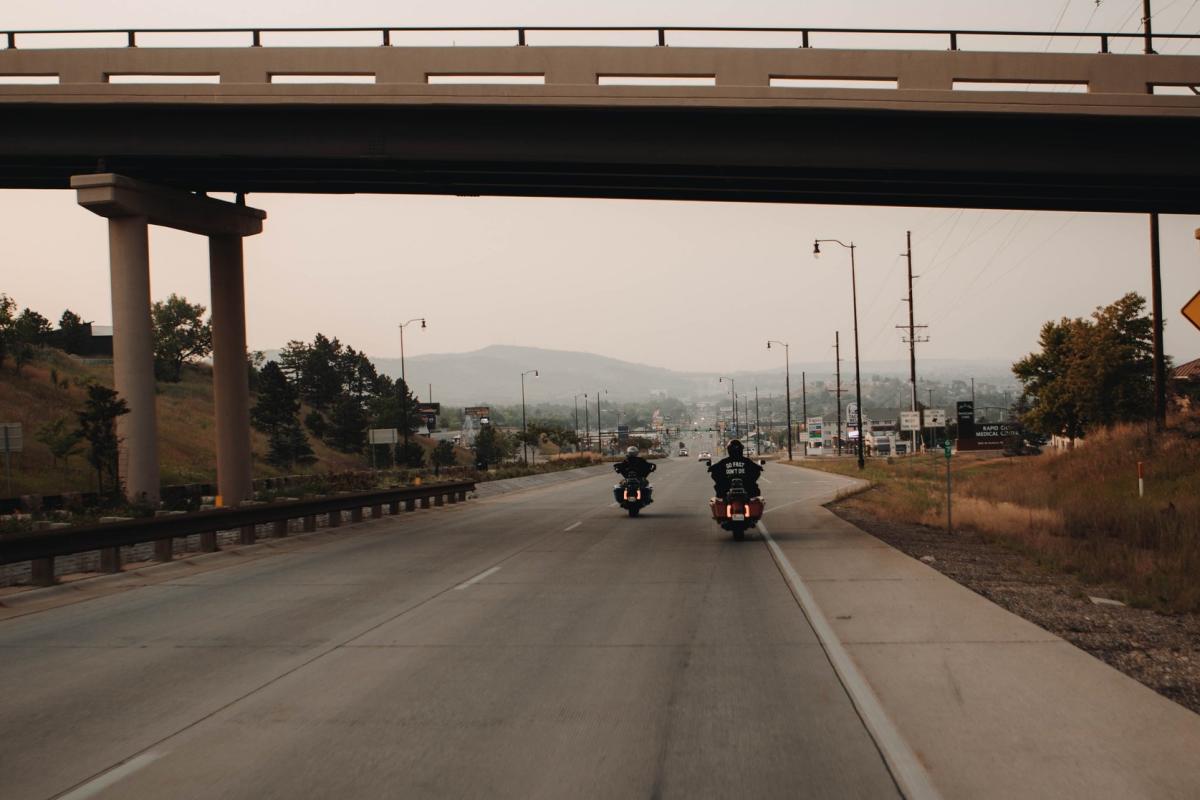 group of bikers entering rapid city down mount rushmore road