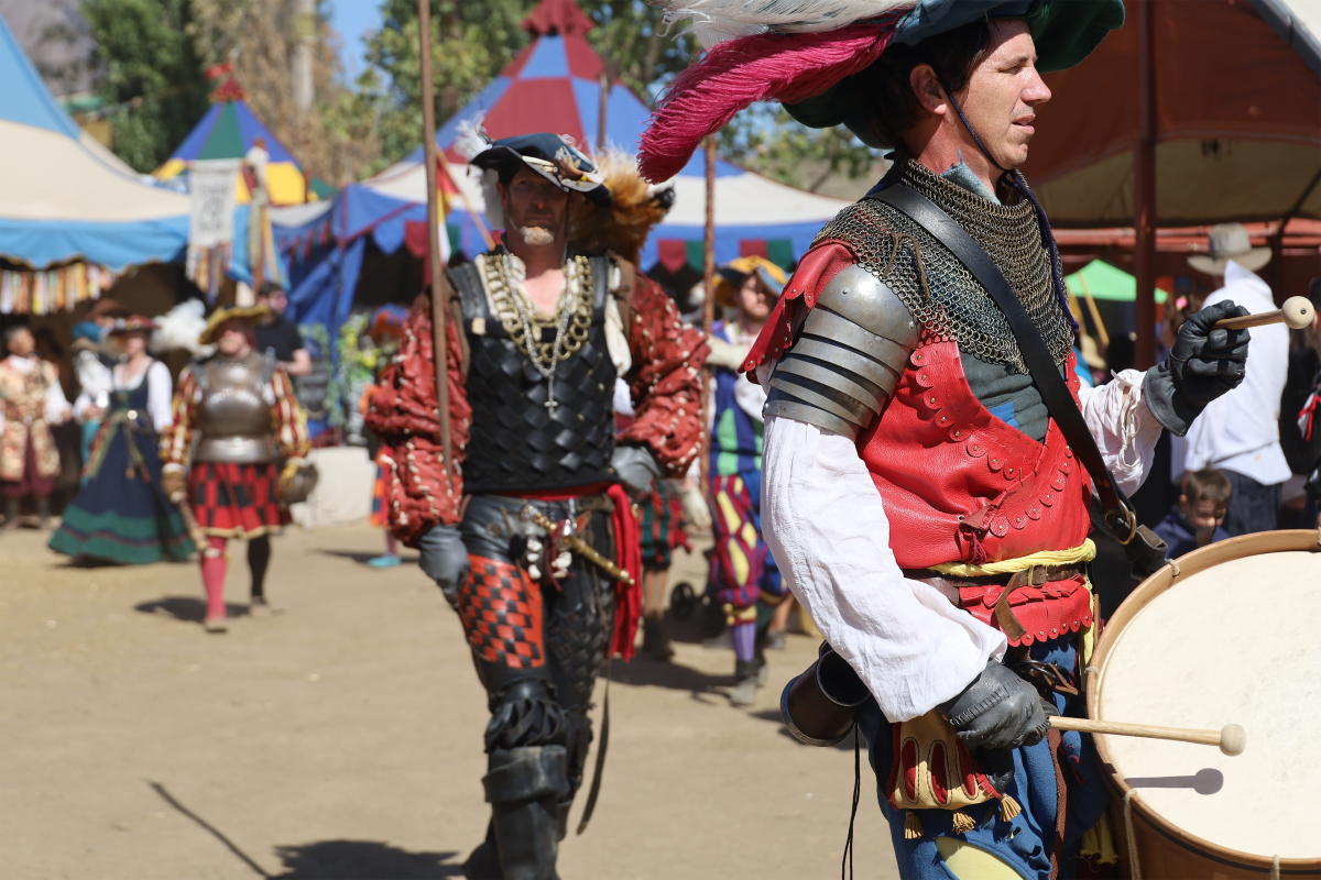 A man in costume playing a drum at the Koroneburg Renaissance Festival in Eastvale, CA