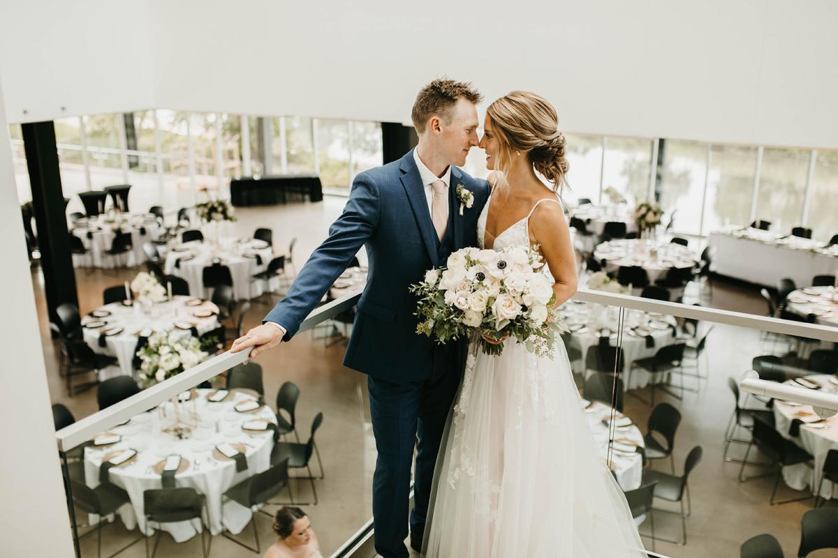 Wedding couple on staircase of Rochester Art Center