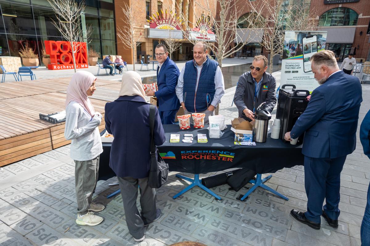 Experience Rochester staff hands out free coffee, donuts and popcorn at Peace Plaza on May 4, 2022