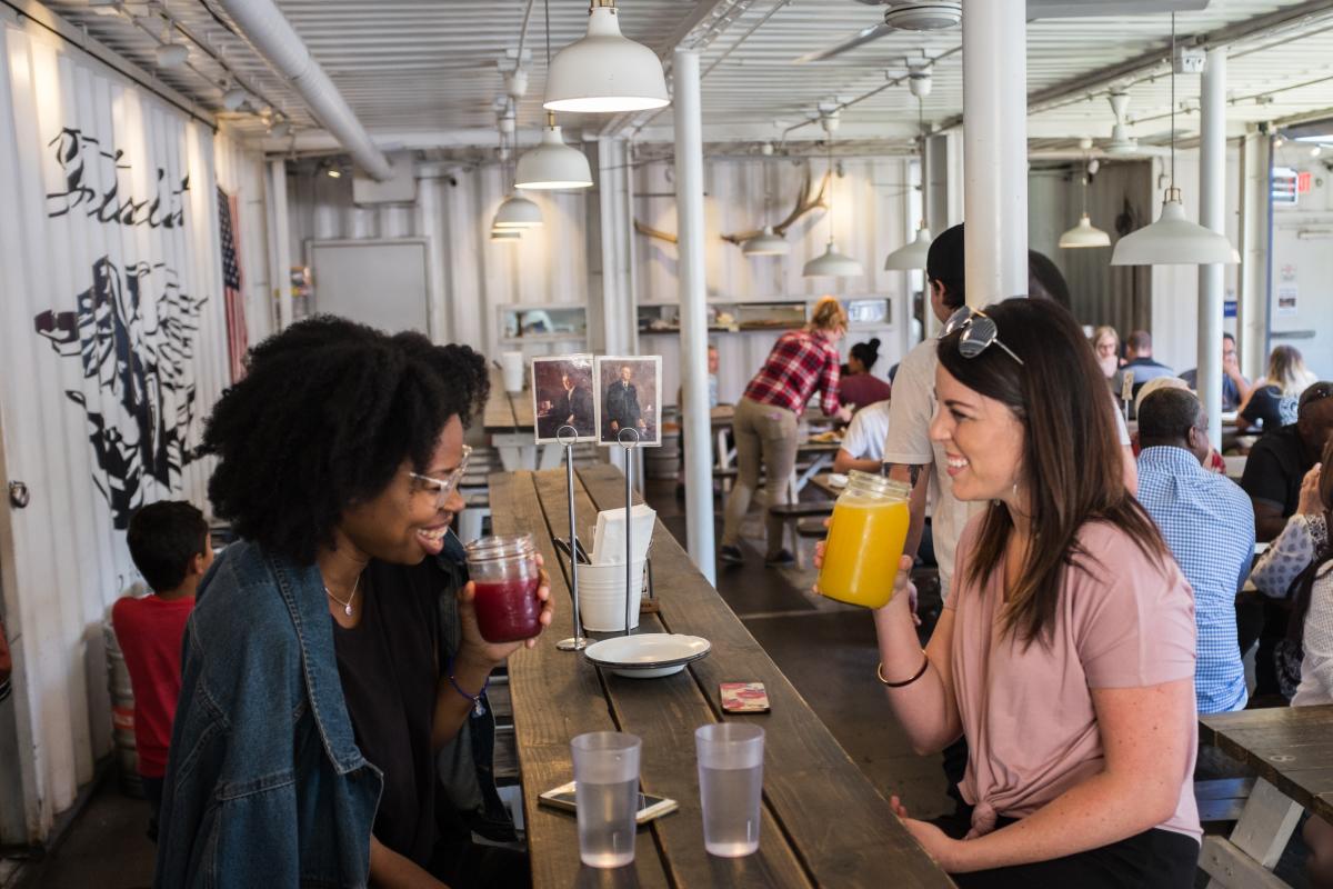 girls sharing drinks at a restaurant