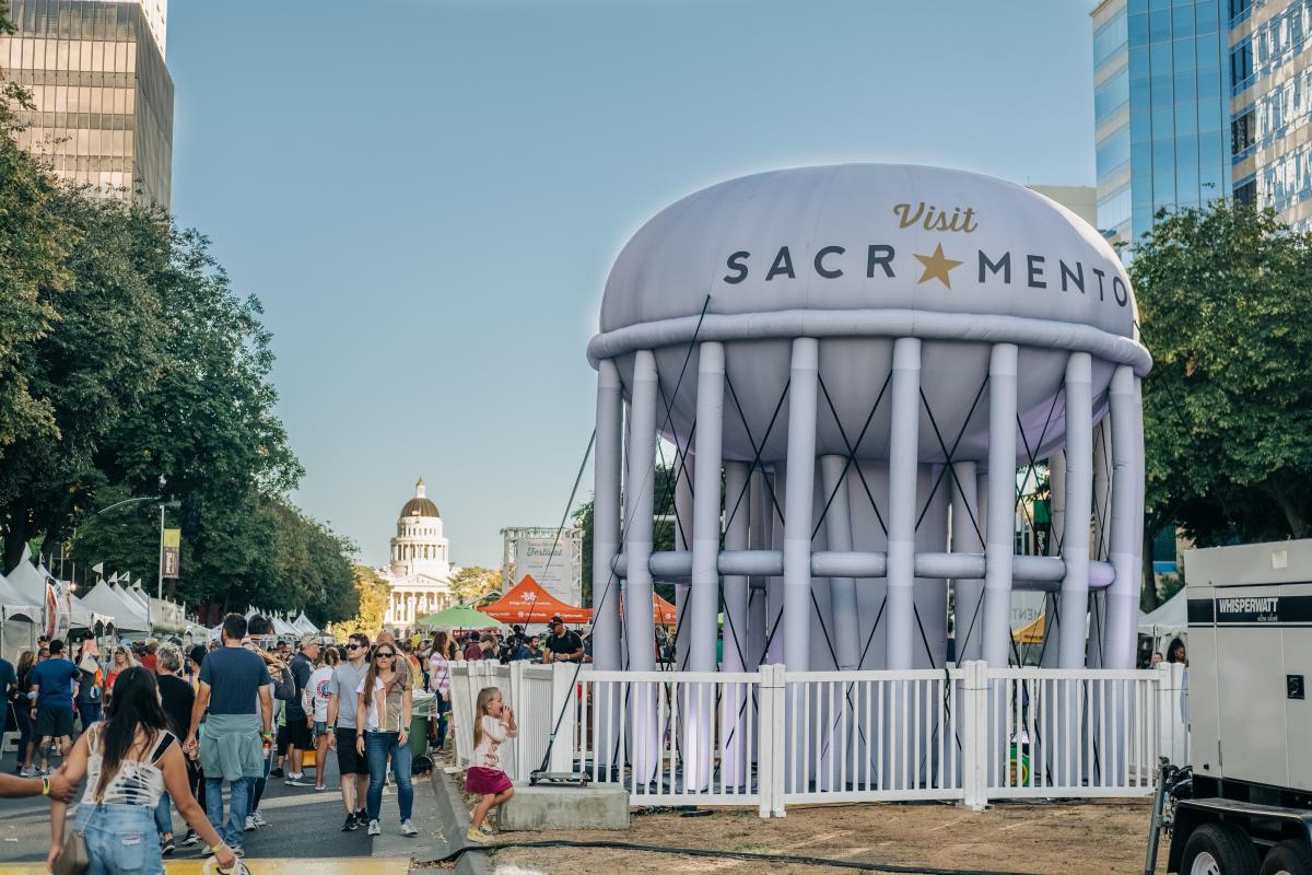 crowd and inflated water tower at farm to fork festival