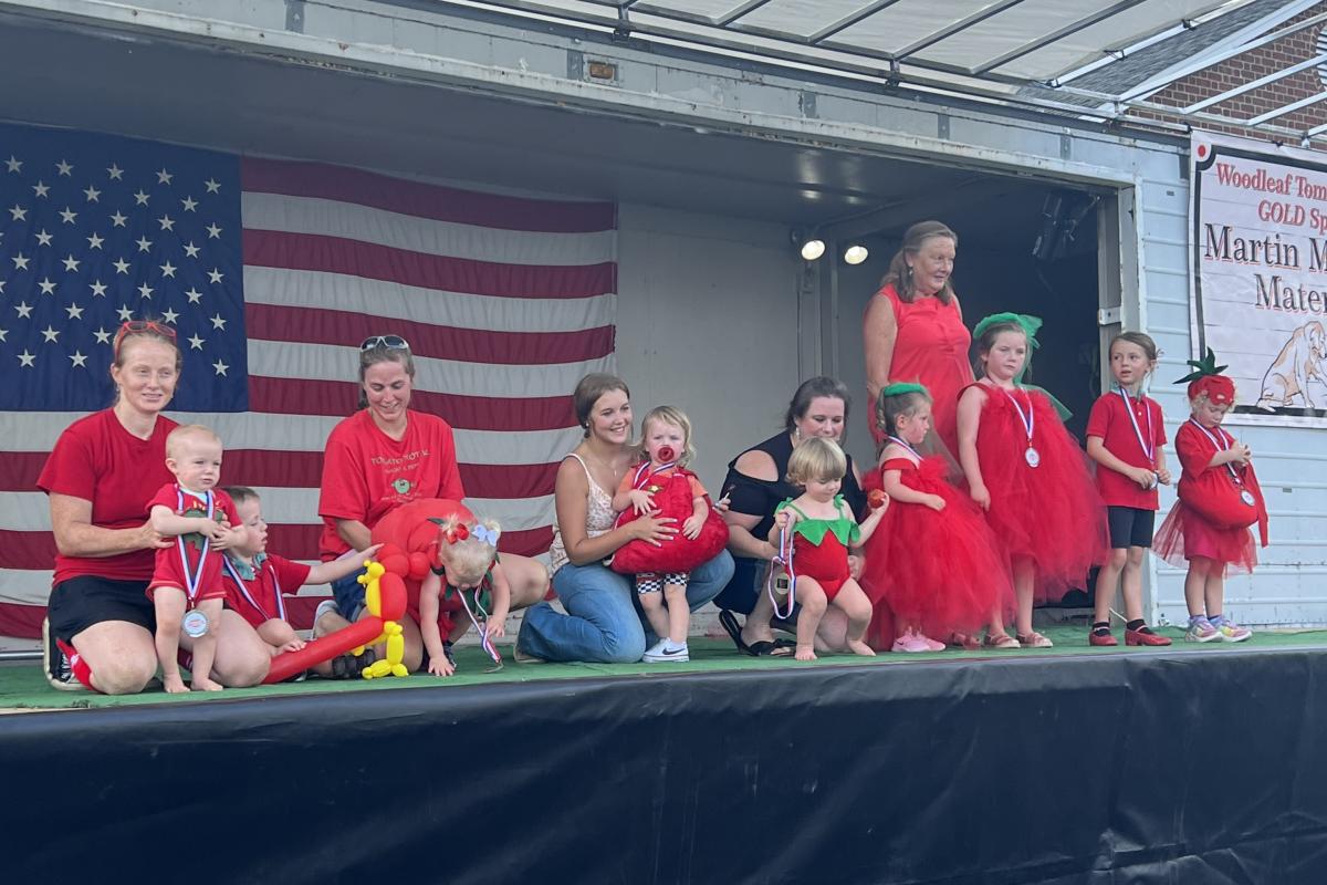 Kids dressed up like tomatoes on stage