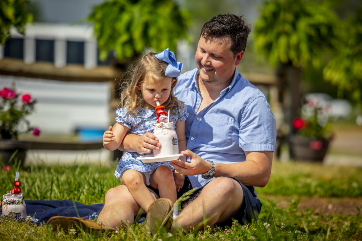 Dad and daughter with milkshake at Patterson Farm