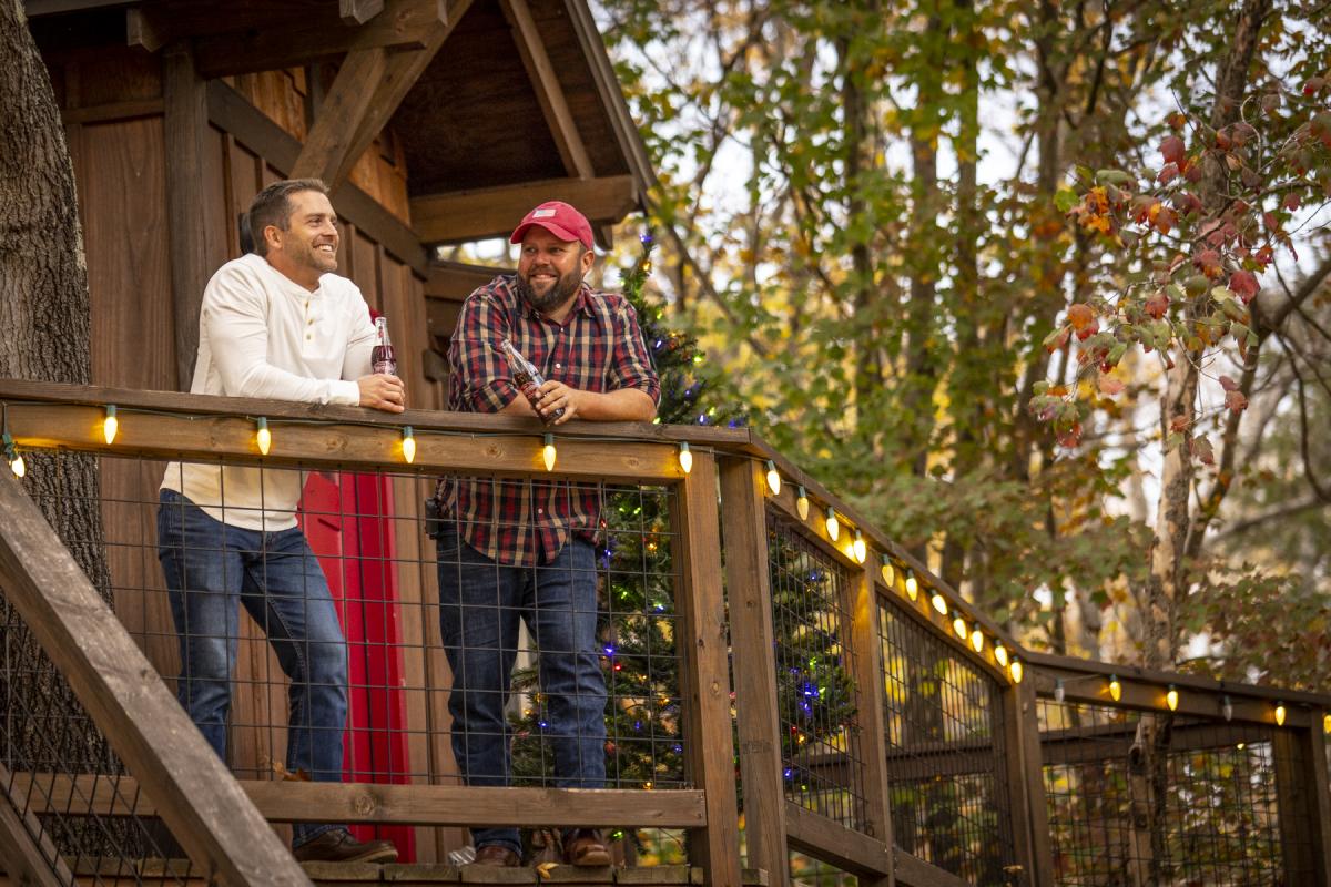 Men on Deck of Cherry Treesort Treehouse during the Holidays