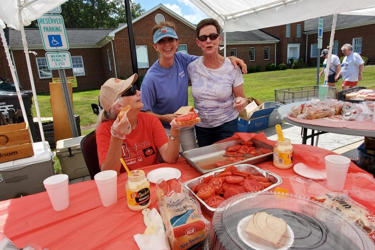 Group making tomato sandwiches at Woodleaf Tomato Festival