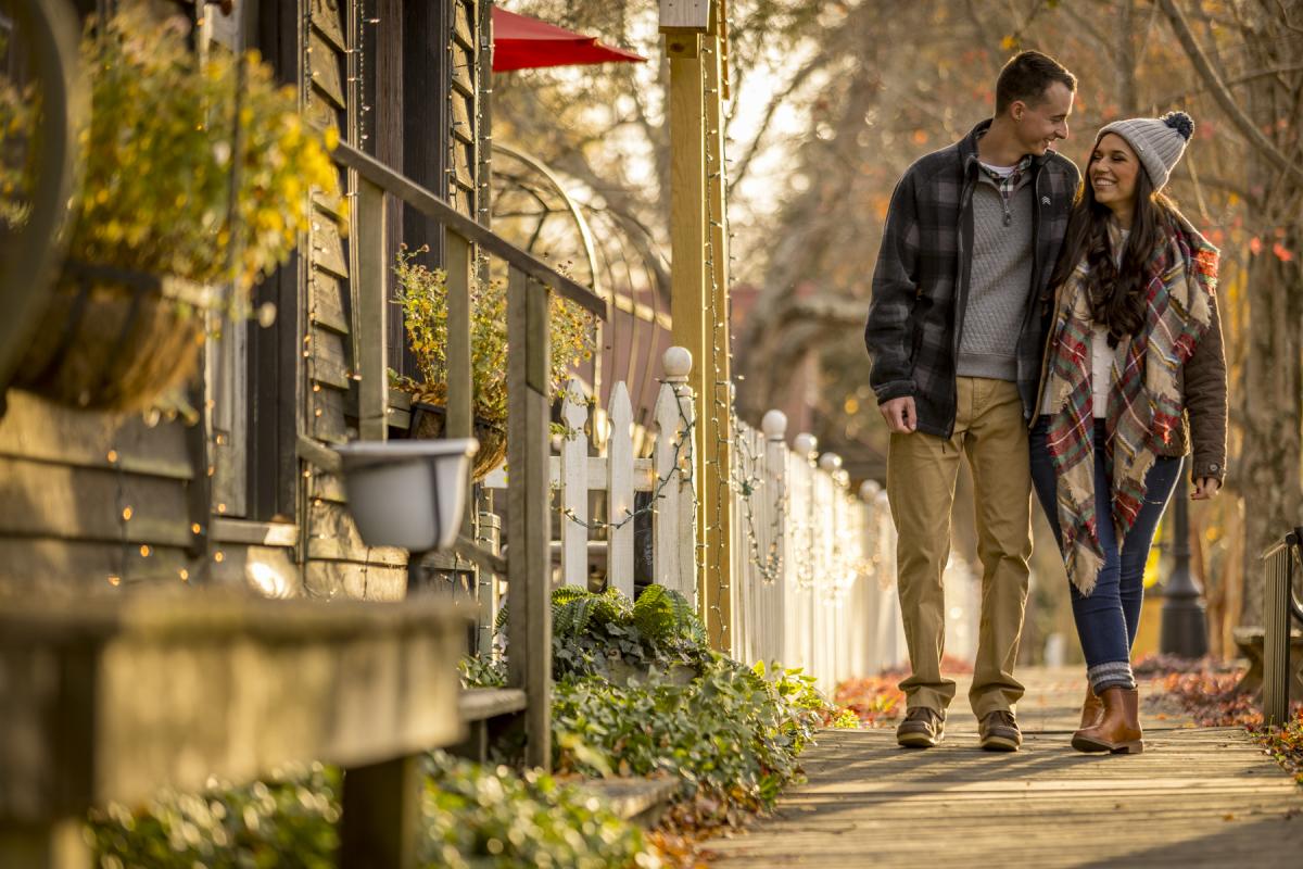 Couple in winterwear walking through historic town