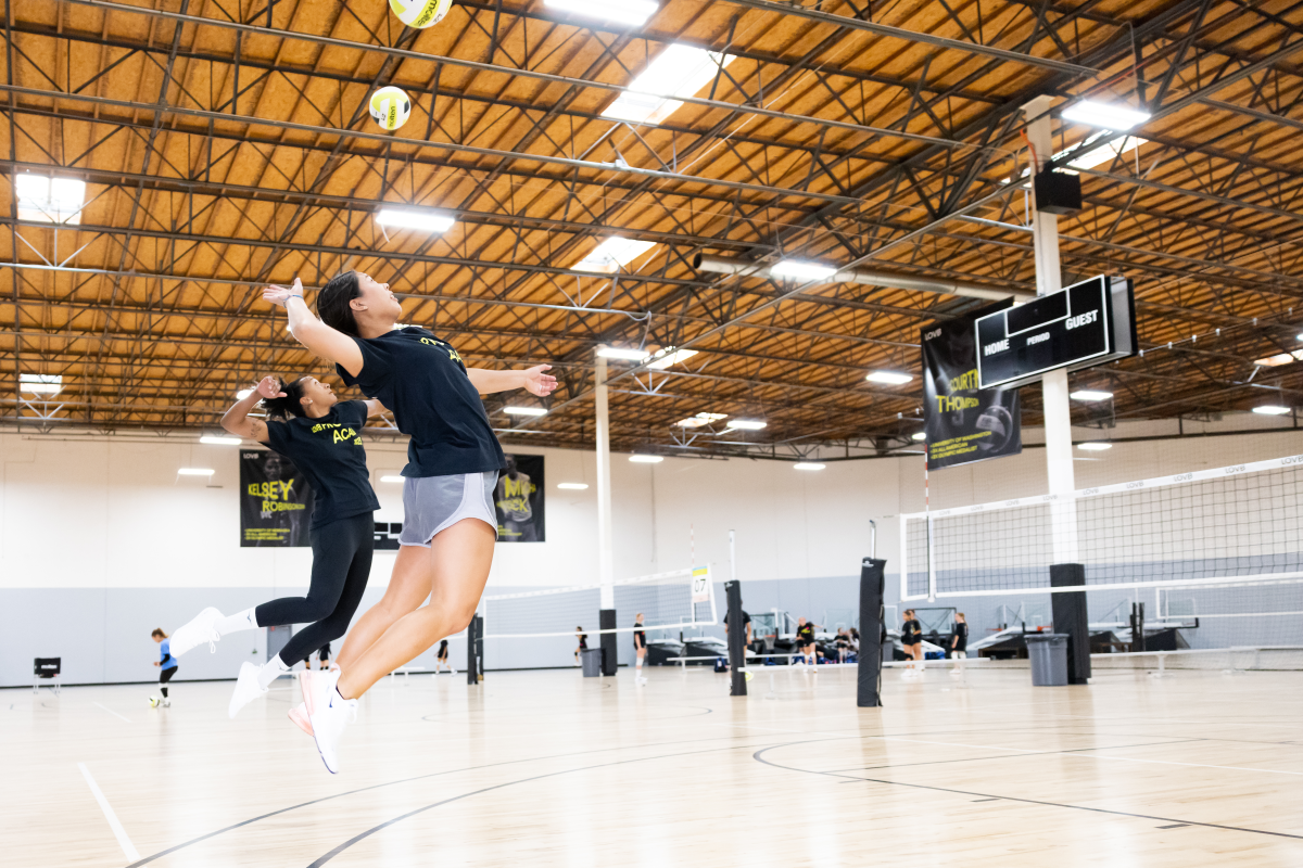 Two girls playing volleyball