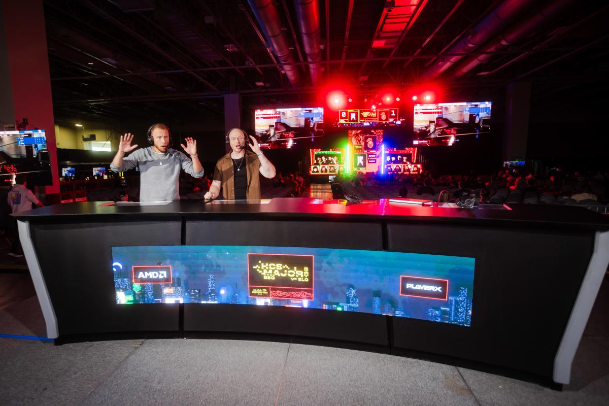 Commentators at a desk are shocked by the game performance