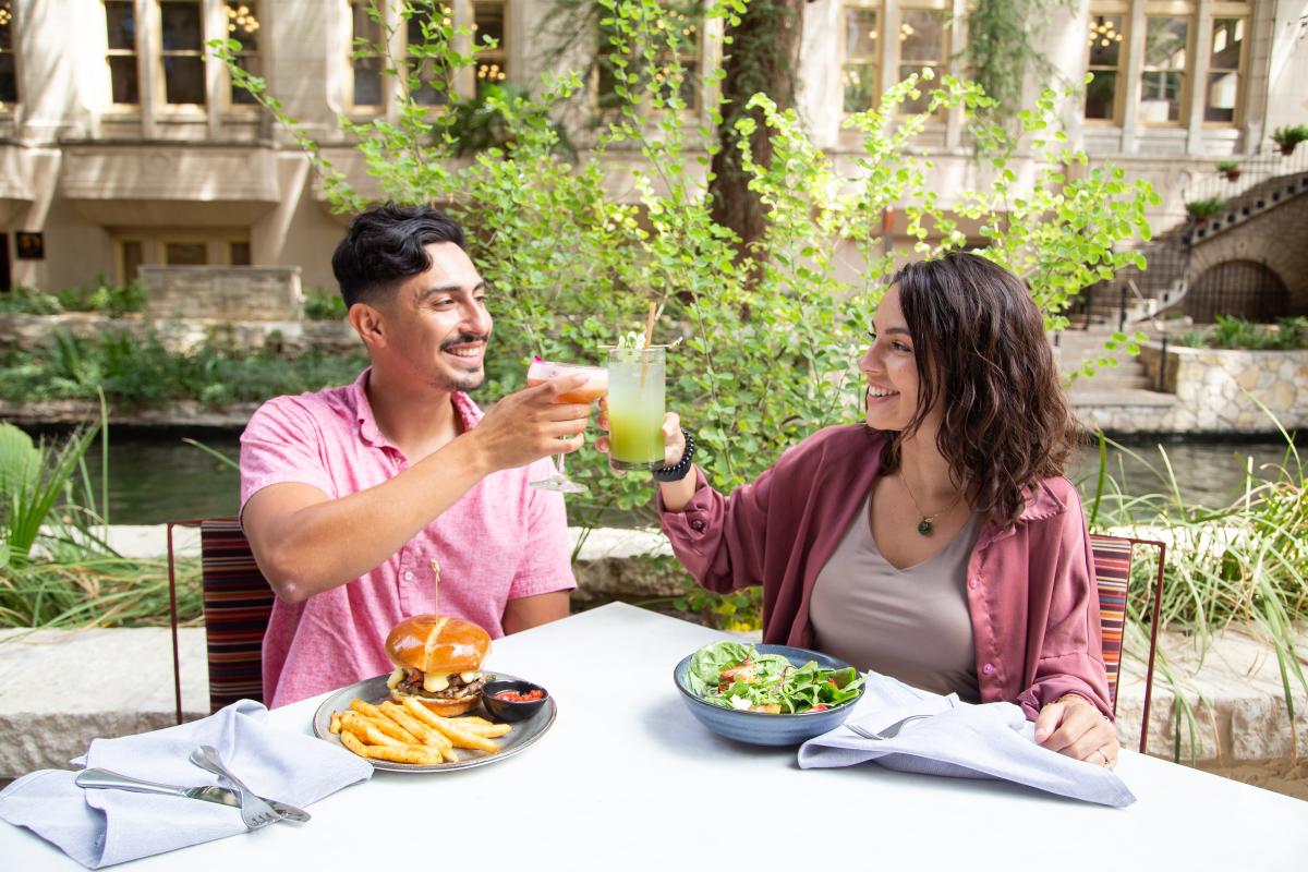 Couple cheers and dines on the River Walk