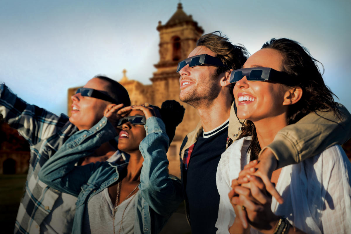 Group of people with protective sunglasses on in front of San Antonio Missions National Historical Park