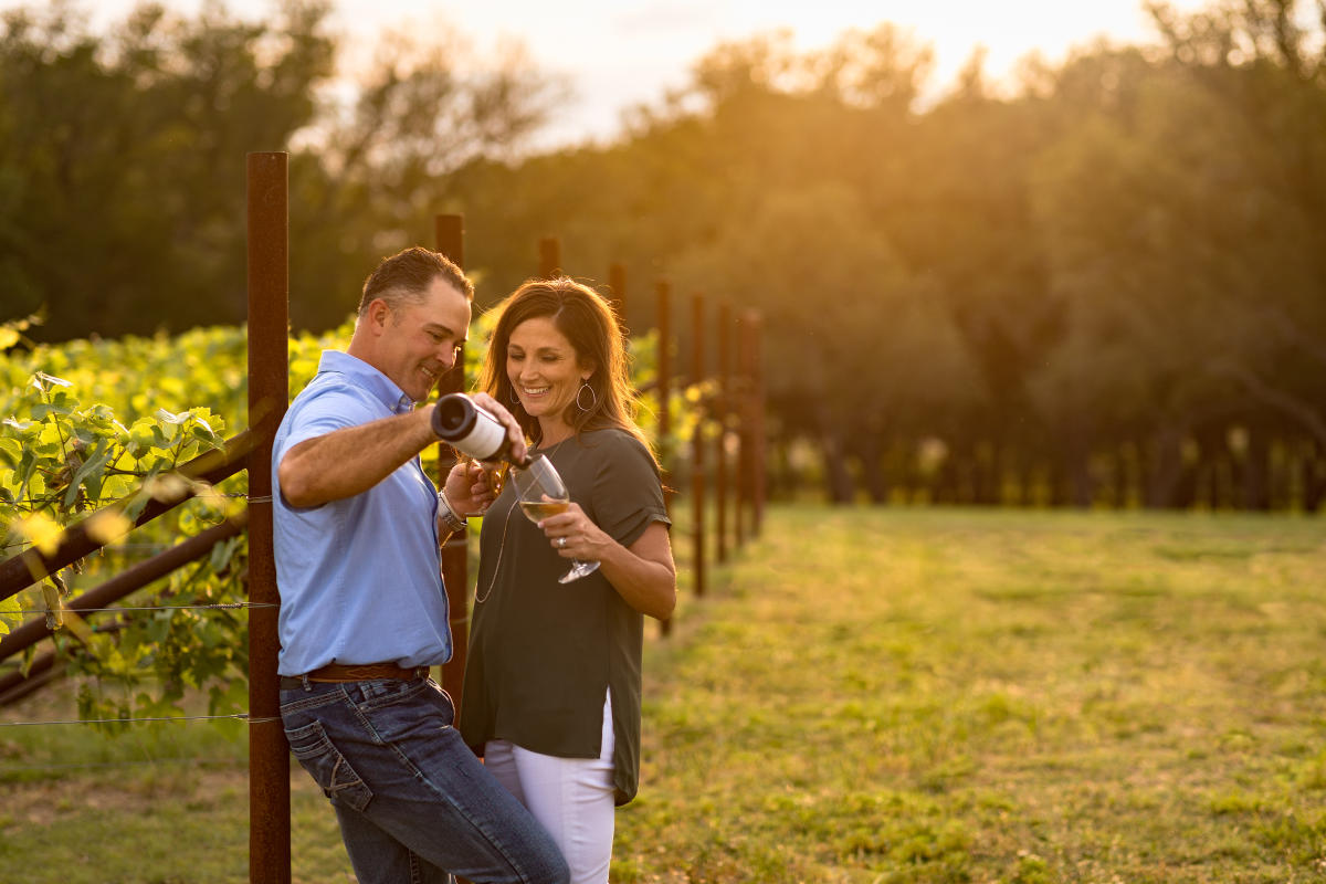 Man and woman enjoying wine at Signor Vineyards in Fredericksburg