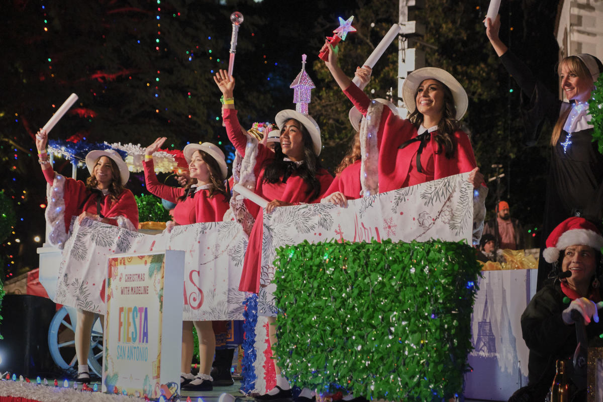 people waving on barge to guests at ford holiday river parade