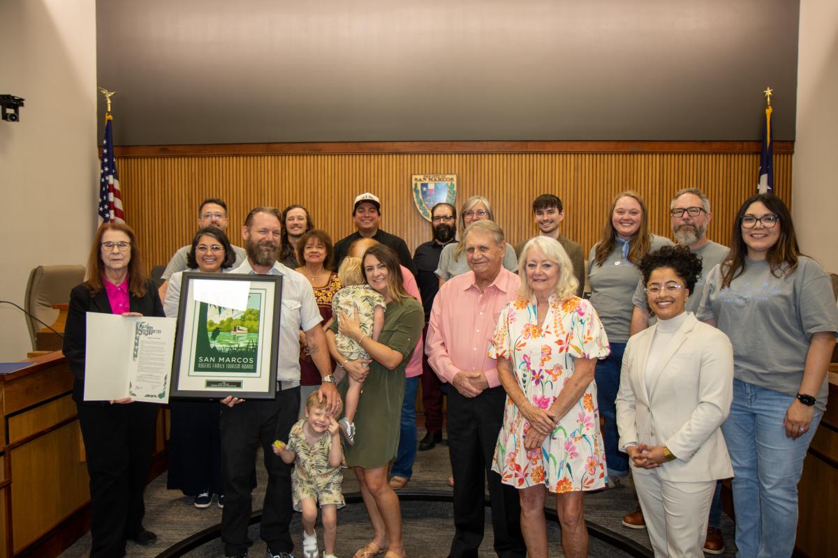 Cody Taylor, his family, and City of San Marcos staff take a group photo after the proclamation declaring him the 2026 Rogers Family Tourism Award recipient.