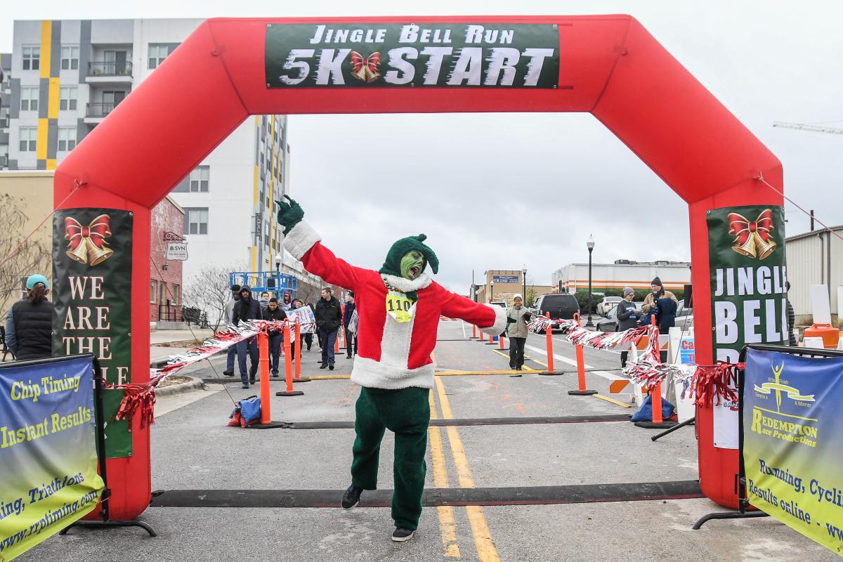 The Grinch passes the finish line at the Jingle Bell 5K in San Marcos, Texas