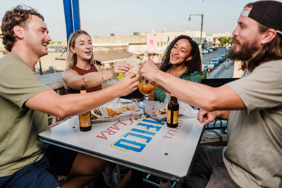 Two couples cheers their tacos at Blind Salamander Cantina in Downtown San Marcos