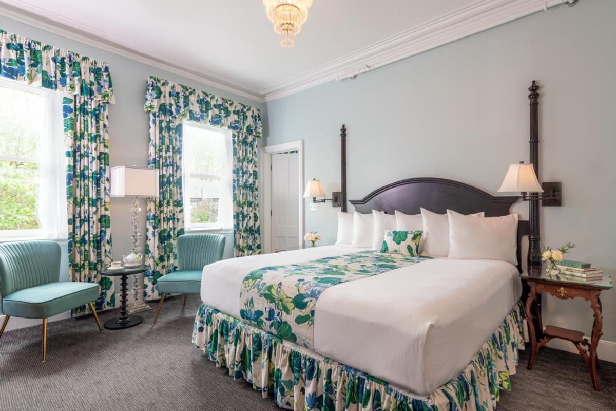 Guest room with two large windows, blue and white decor