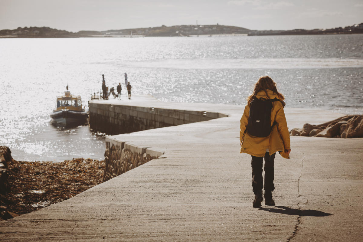 Girl walking along quay on Tresco
