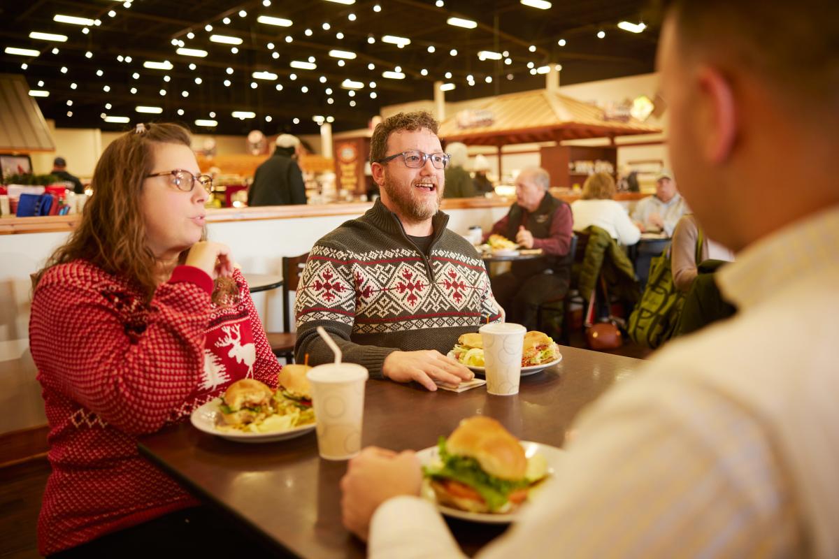 people enjoying lunch inside a busy cafe