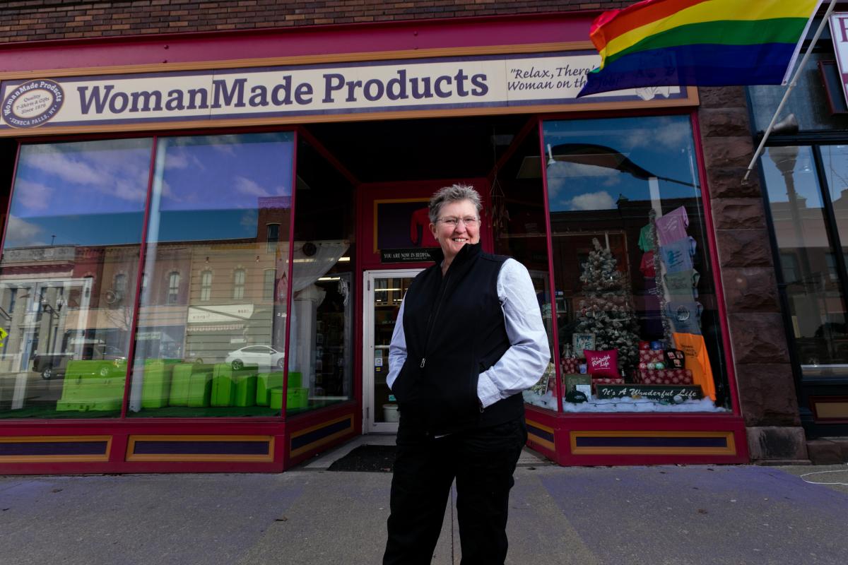 Outside of storefront with owner in foreground