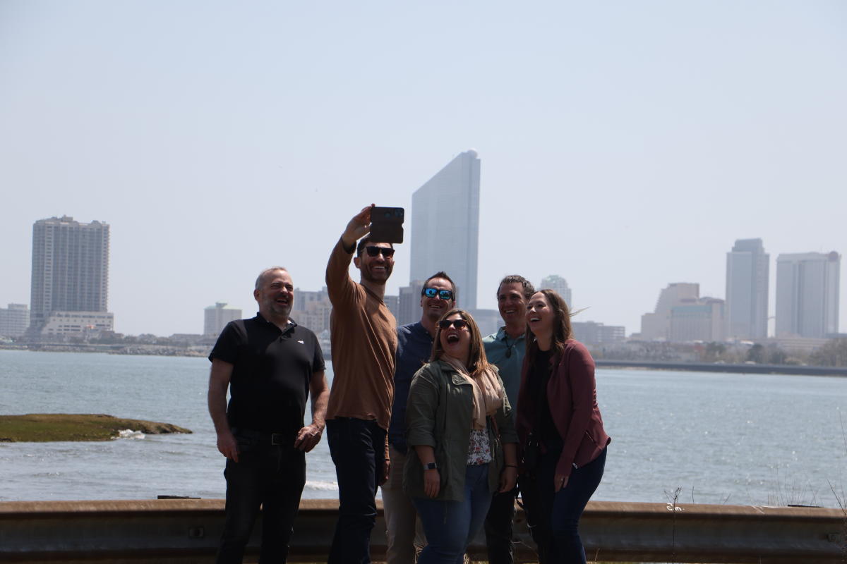 6 people standing in front of a skyline