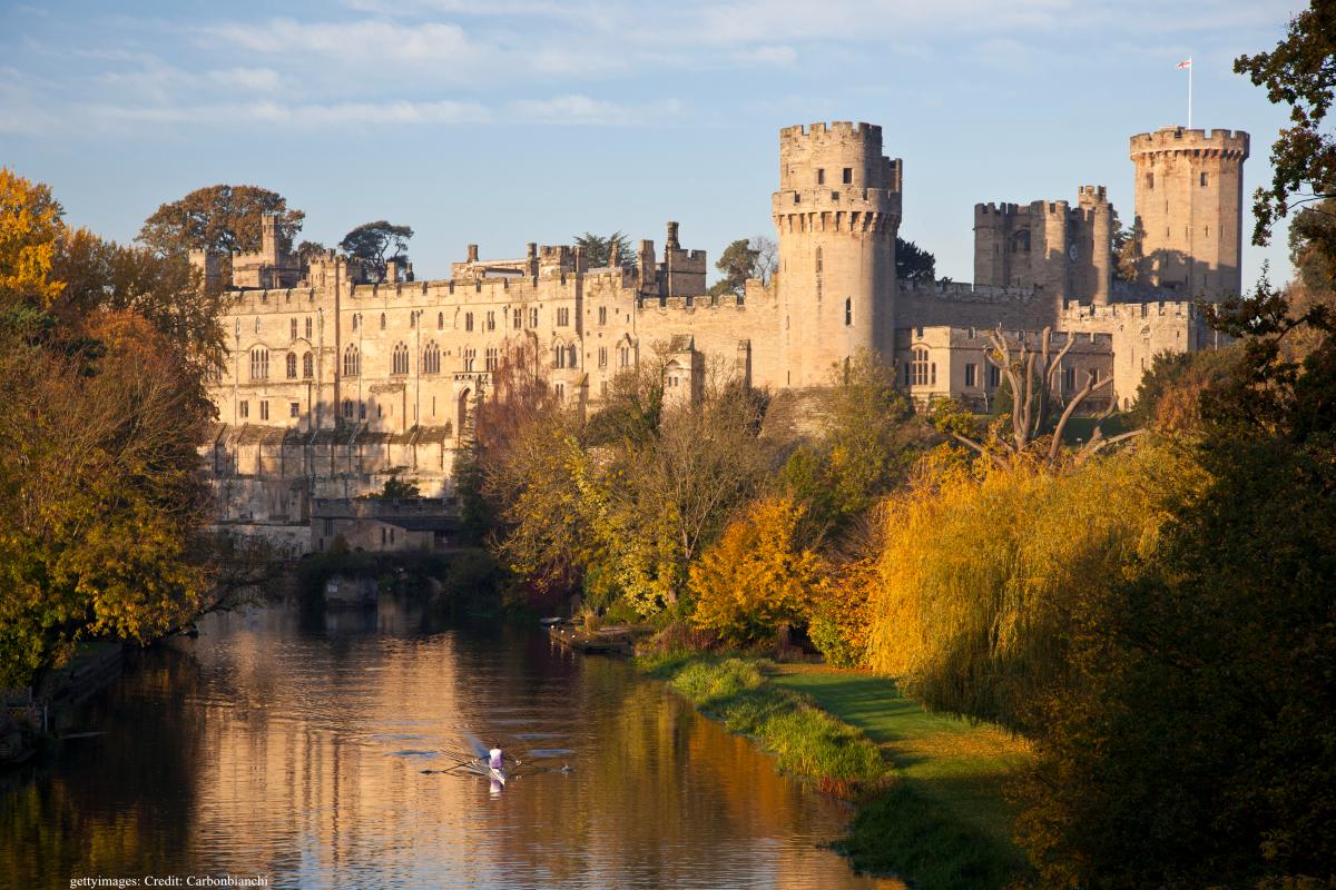 Warwick Castle surrounded by autumn foliage