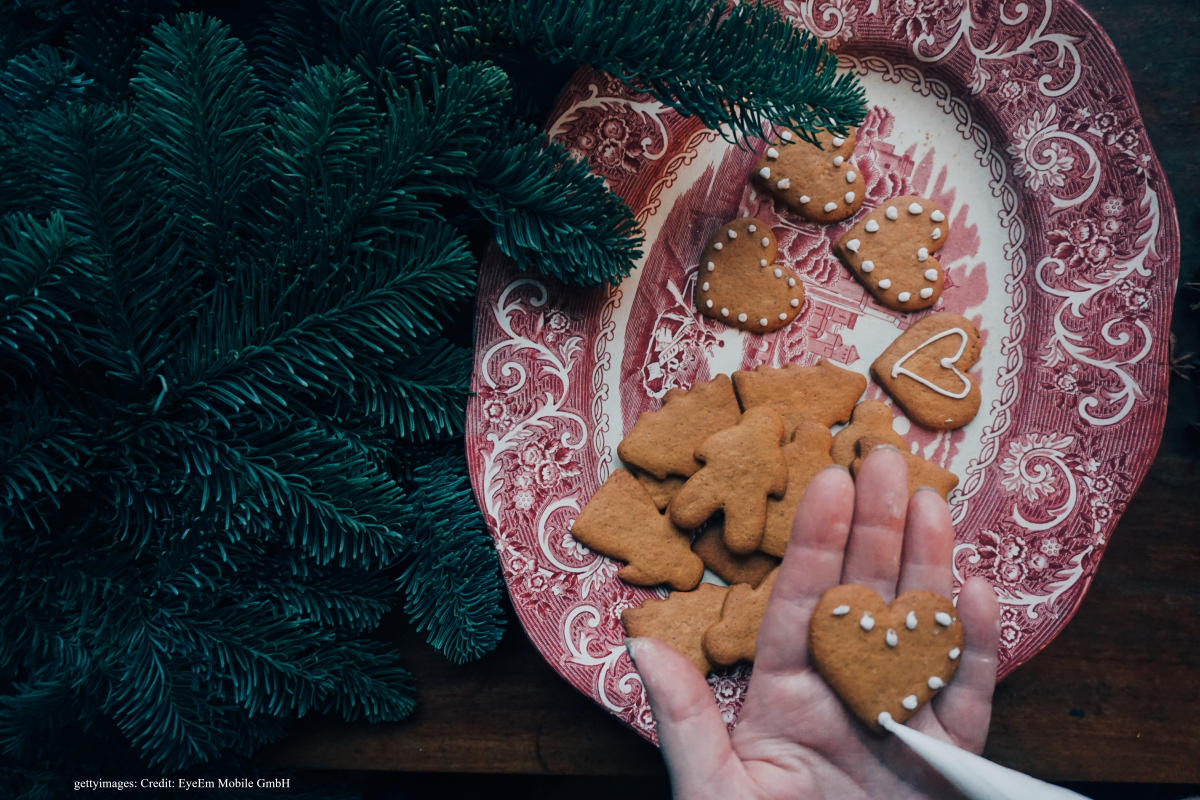 Decorated cookies are placed on an oval china plate in the centre of a table in Norway.