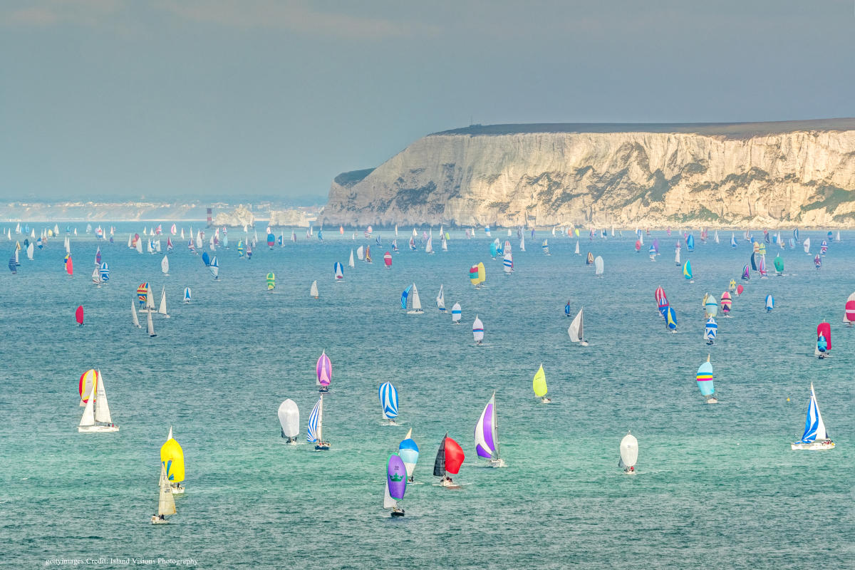 Colourful sails of boats at full mast off the coast of Isle of Wight during Cowes Week