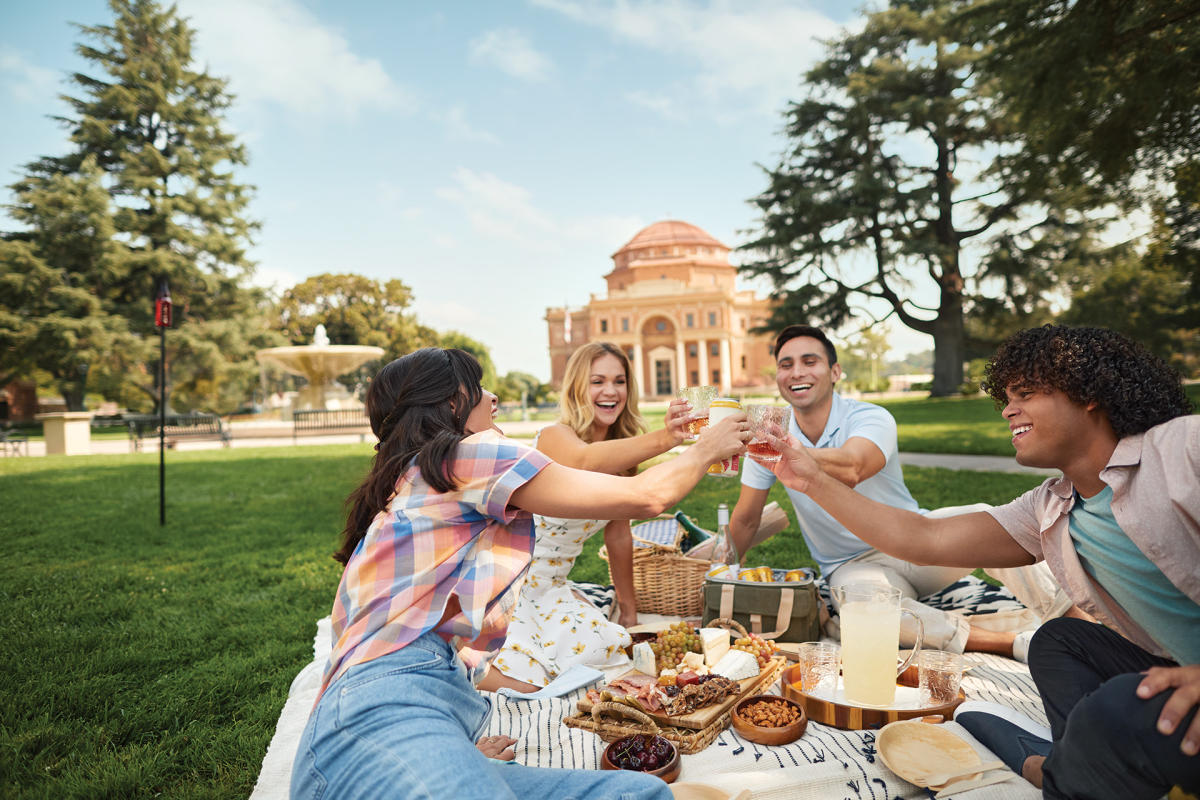 Friends enjoying a picnic on the lawn of the Sunken Gardens in Atascadero